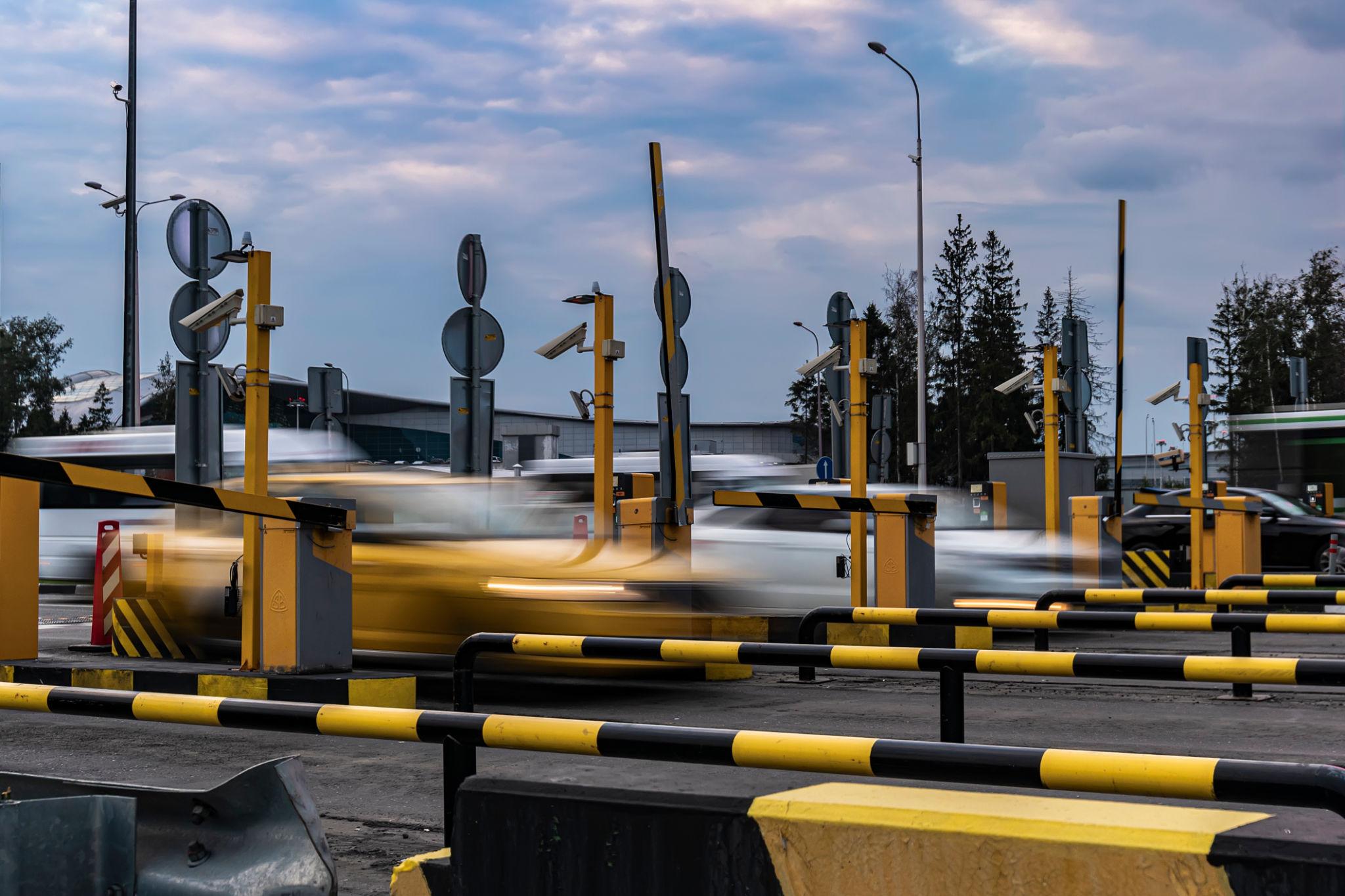 Airport parking entrance with vehicles arriving during a busy travel period