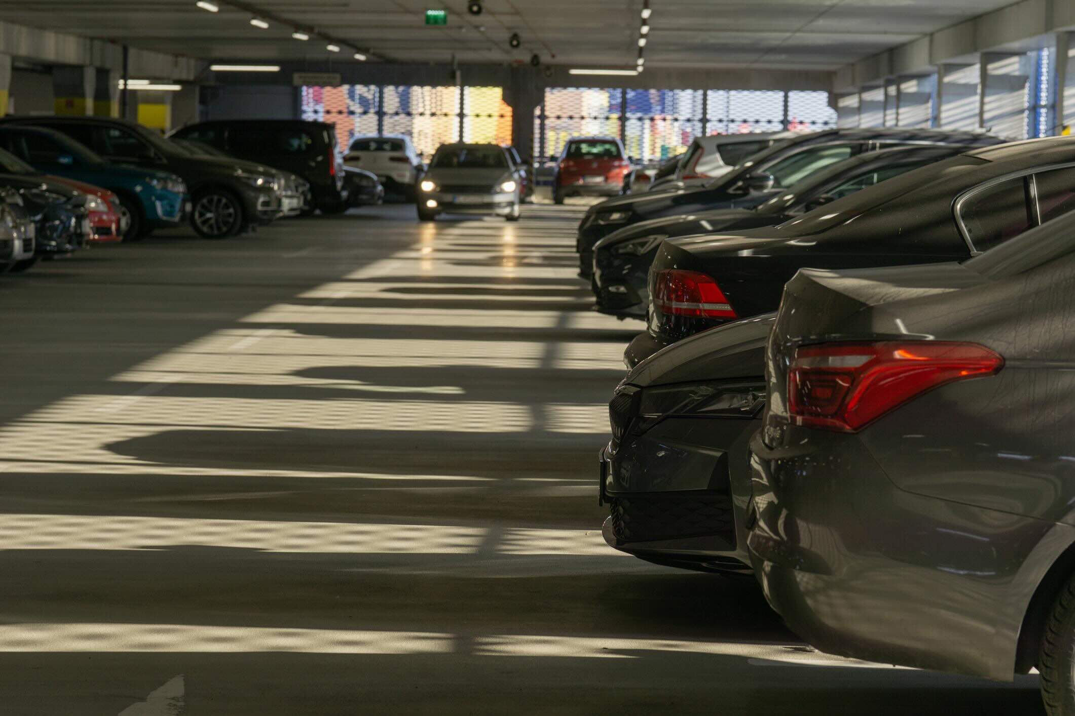 Covered parking garage with cars and shaded environment near LAX
