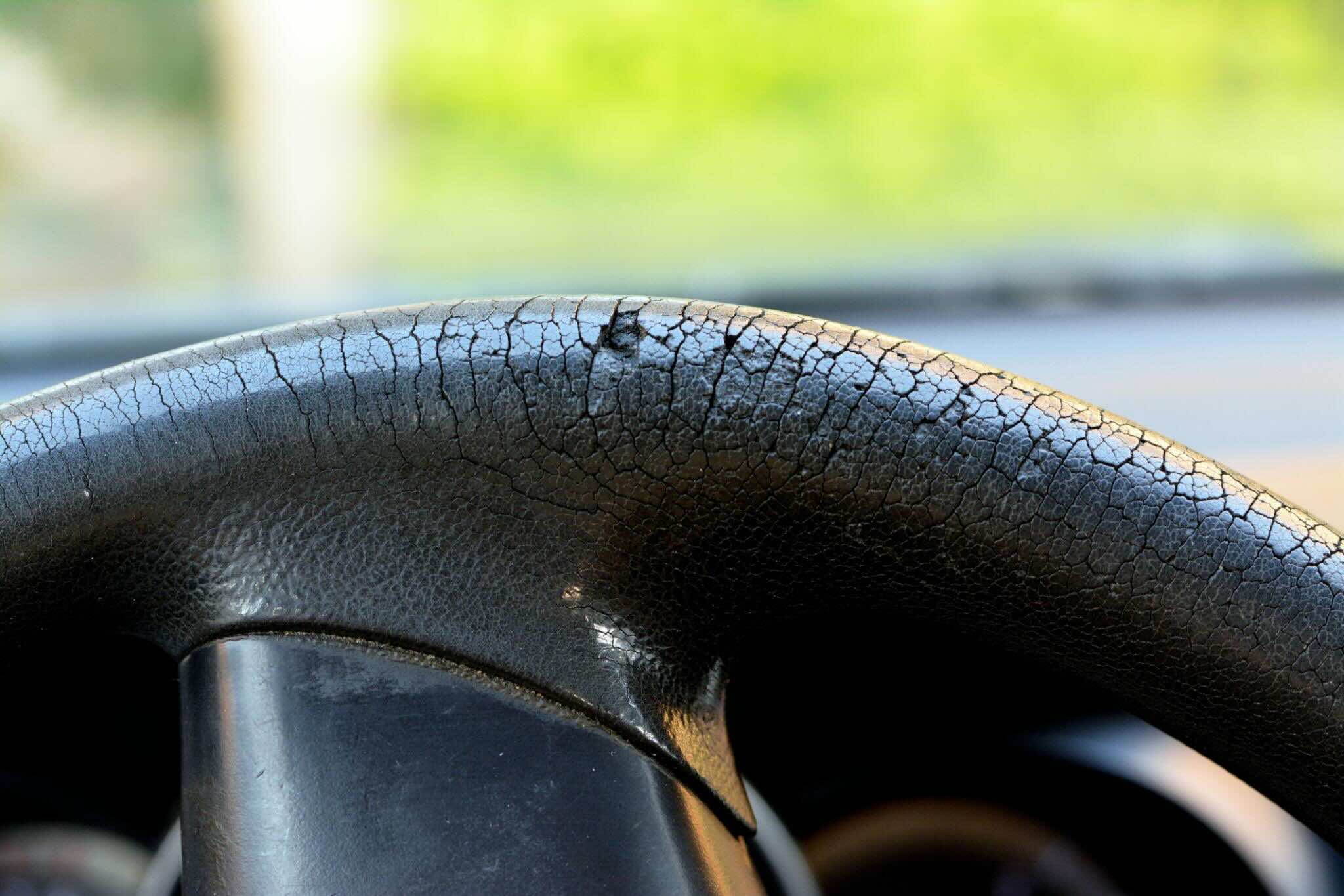 Cracked steering wheel from heat and sun damage inside car