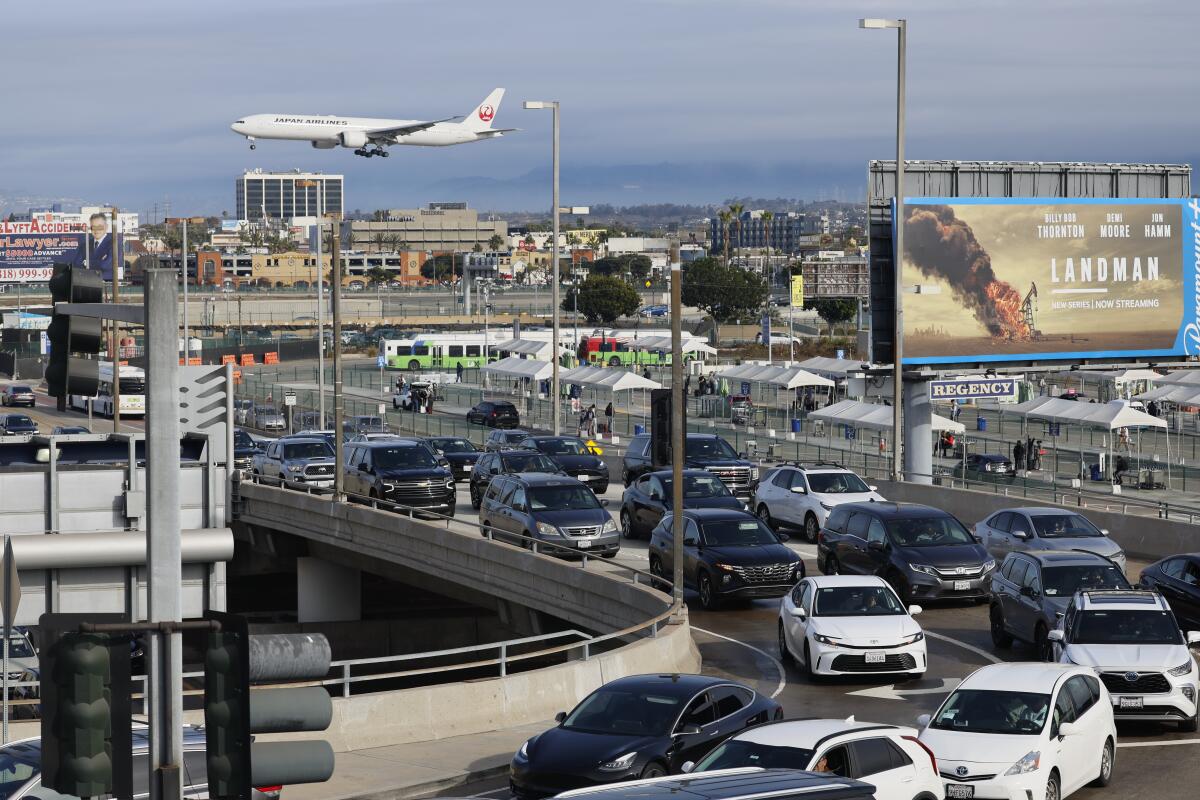 Heavy traffic near LAX with an airplane approaching the airport