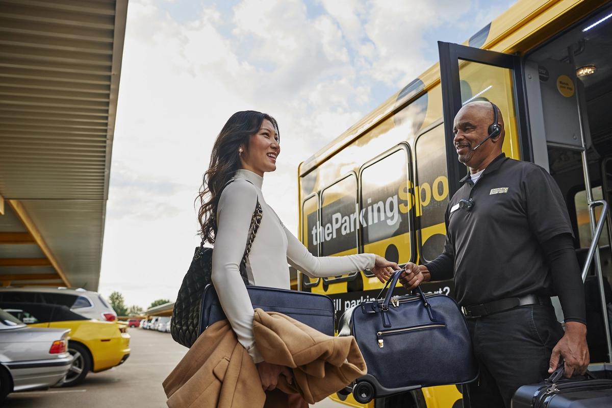Traveler boarding The Parking Spot shuttle at an off-airport parking lot near LAX